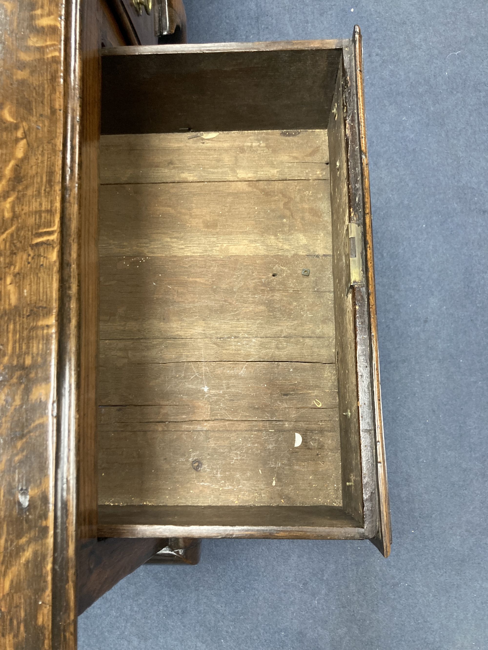 A late 17th century oak dresser base on cabriole front legs, length 180cm, depth 43cm, height 77cm